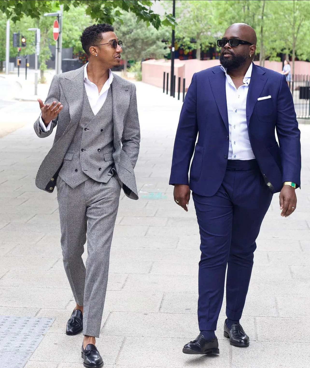 Two men walking and talking while wearing Reveal Suits