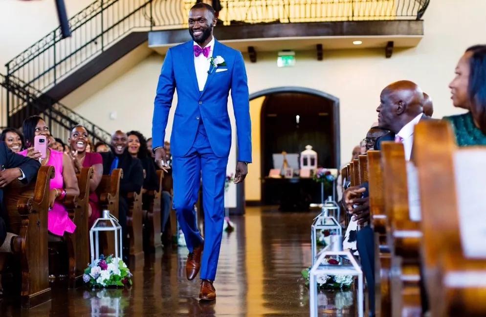Man walking in a wedding while wearing a Reveal Suit.