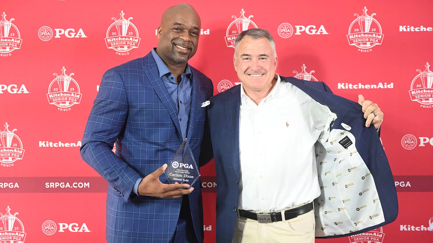 Carlton holding an award from PGA.