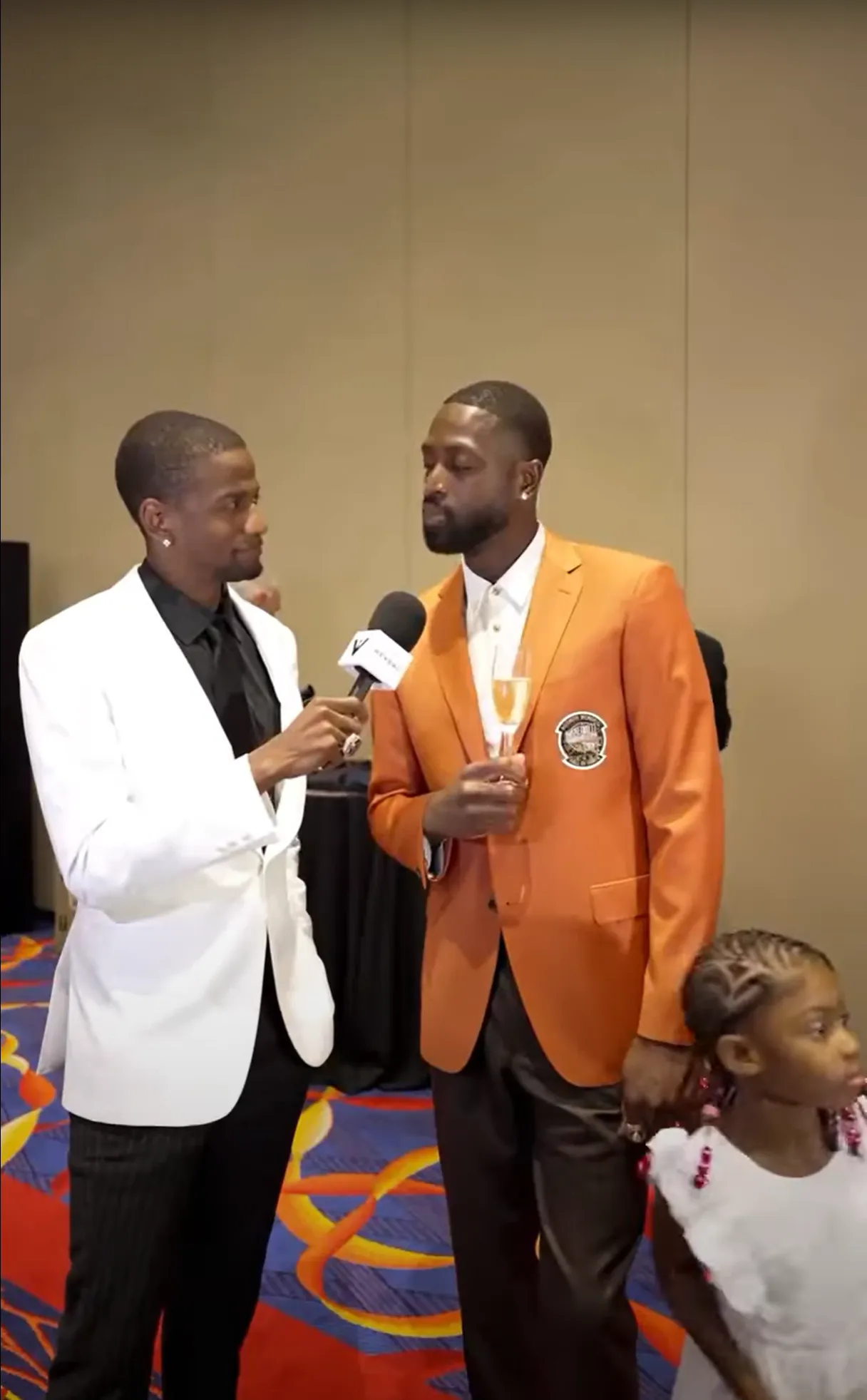 Reporter interviewing a man wearing an Orange Reveal Blazer